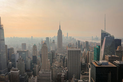 Aerial view of buildings in city against sky