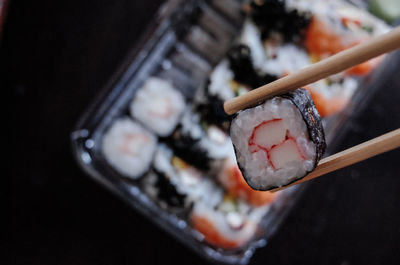 Close-up of chopsticks with sushi