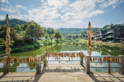 Scenic view of river by buildings against sky