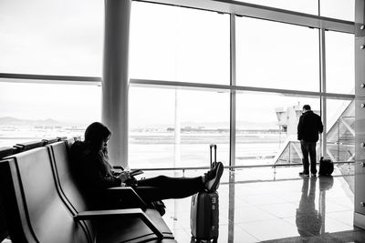 People with luggage waiting at airport