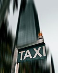 Low angle view of sign on road against sky