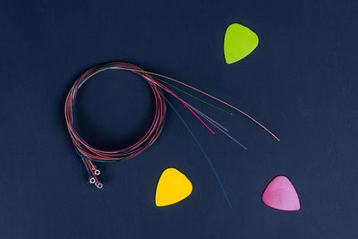 High angle view of multi colored umbrellas on table against black background