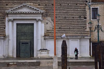 People walking in front of building