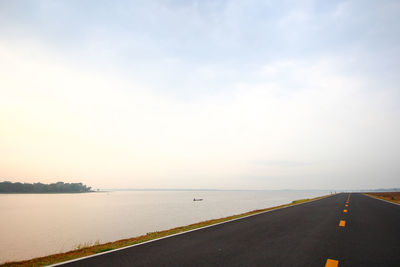 Road by sea against sky
