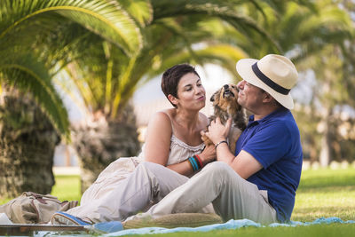 Man and woman with dog outdoors