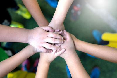 Close-up of people stacking hands