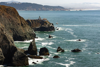 Scenic view of sea and rocks against sky