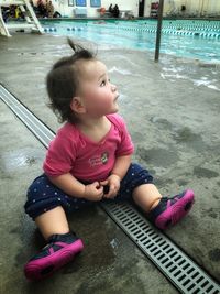 Portrait of cute girl sitting in water