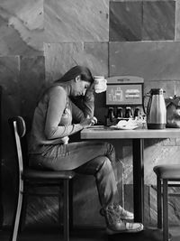 Woman sitting on table