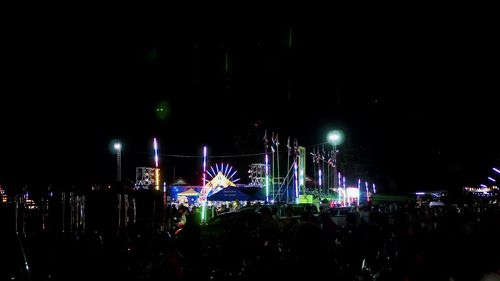 Crowd at music concert in city at night