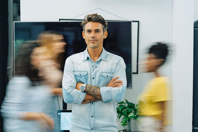 Portrait of a middle age attractive man standing at office