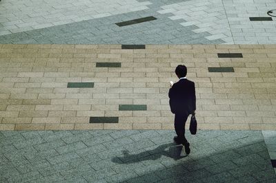 High angle view of man walking in city