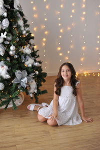 Portrait of girl playing with christmas tree