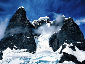 Scenic view of snowcapped mountains against sky in antarctica 