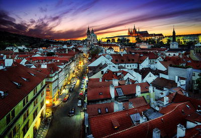 High angle view of illuminated buildings in town against sky during sunset