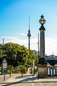 View of street light in city against blue sky