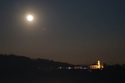 Illuminated lights against sky at night