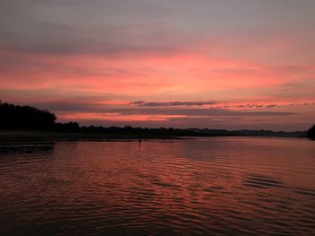 Scenic view of lake against romantic sky at sunset