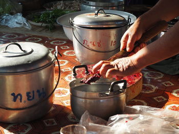 Midsection of person preparing food on table