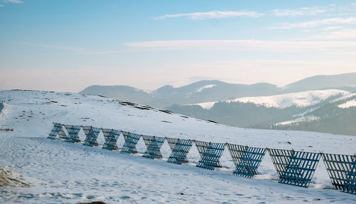 Scenic view of snow covered mountains against sky