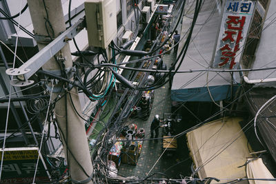 Tilt image of telephone pole amidst buildings in city