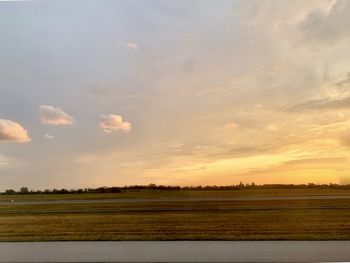 Scenic view of field against sky during sunset