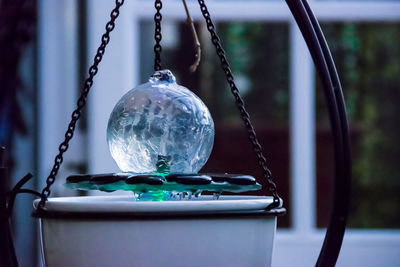 Close-up of crystal ball hanging at home