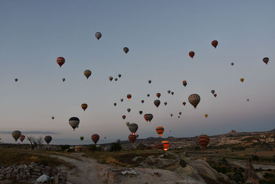 Countless hot air balloons in the gray dawn in cappadocia, turkey