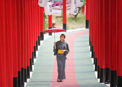 Portrait of woman standing by staircase