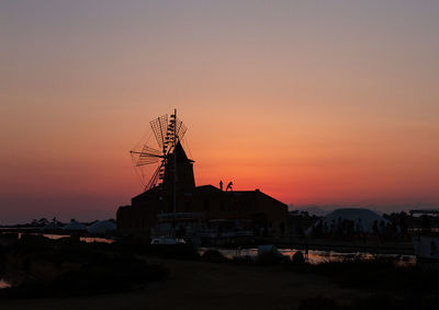 Sunset over windmills in marsala, sicily, italy