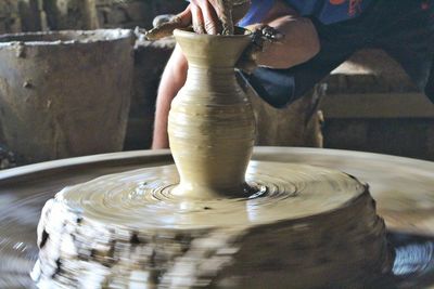 Close-up of man working in mud