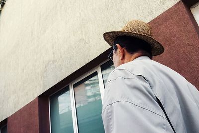 Low angle view of man by building in city