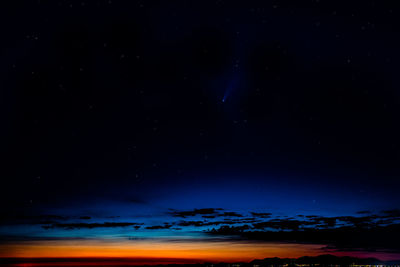 Scenic view of sea against star field at night