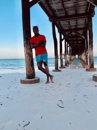 Full length of woman standing at beach