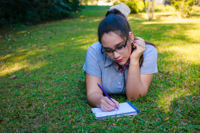 Young woman studying at park