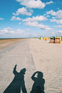 View of beach against cloudy sky