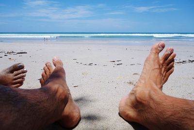 Low section of couple at beach