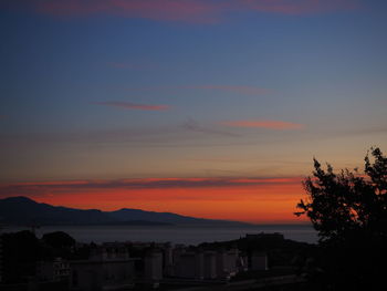 Scenic view of silhouette trees against orange sky