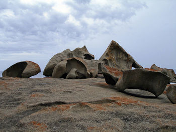 Rocks on beach against sky