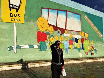 Young woman standing by railing