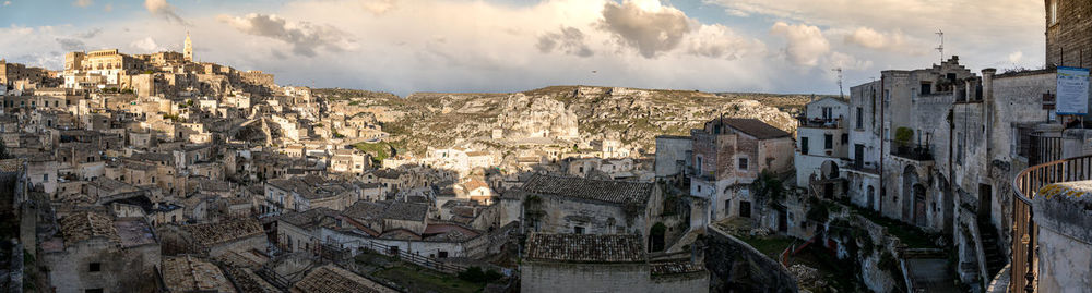 Panoramic view of buildings in city against sky