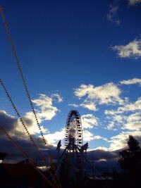 Low angle view of ferris wheel against blue sky