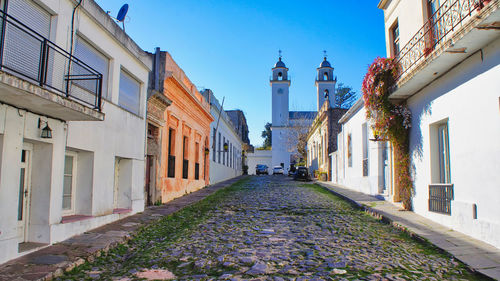 Street amidst buildings against sky in city