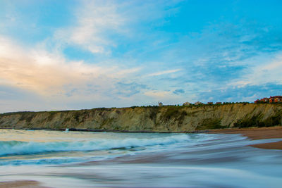 Scenic view of beach against sky during sunset