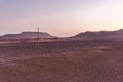 Scenic view of desert against sky during sunset