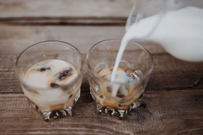 High angle view of coffee being poured on table