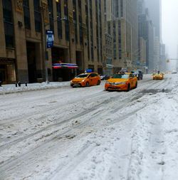 Cars on snow covered city