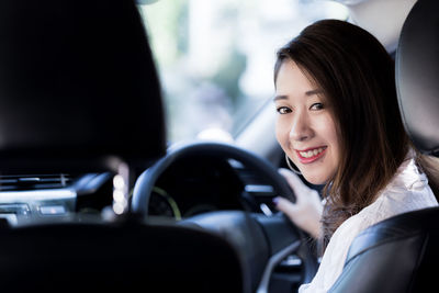 Portrait of smiling woman in car