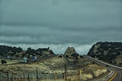 Panoramic view of road against storm clouds