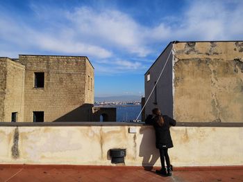 Full length of woman standing against sky